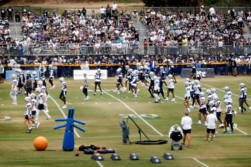 The Dallas Cowboys football team trains before over 4,000 fans at the Cowboys training camp...
