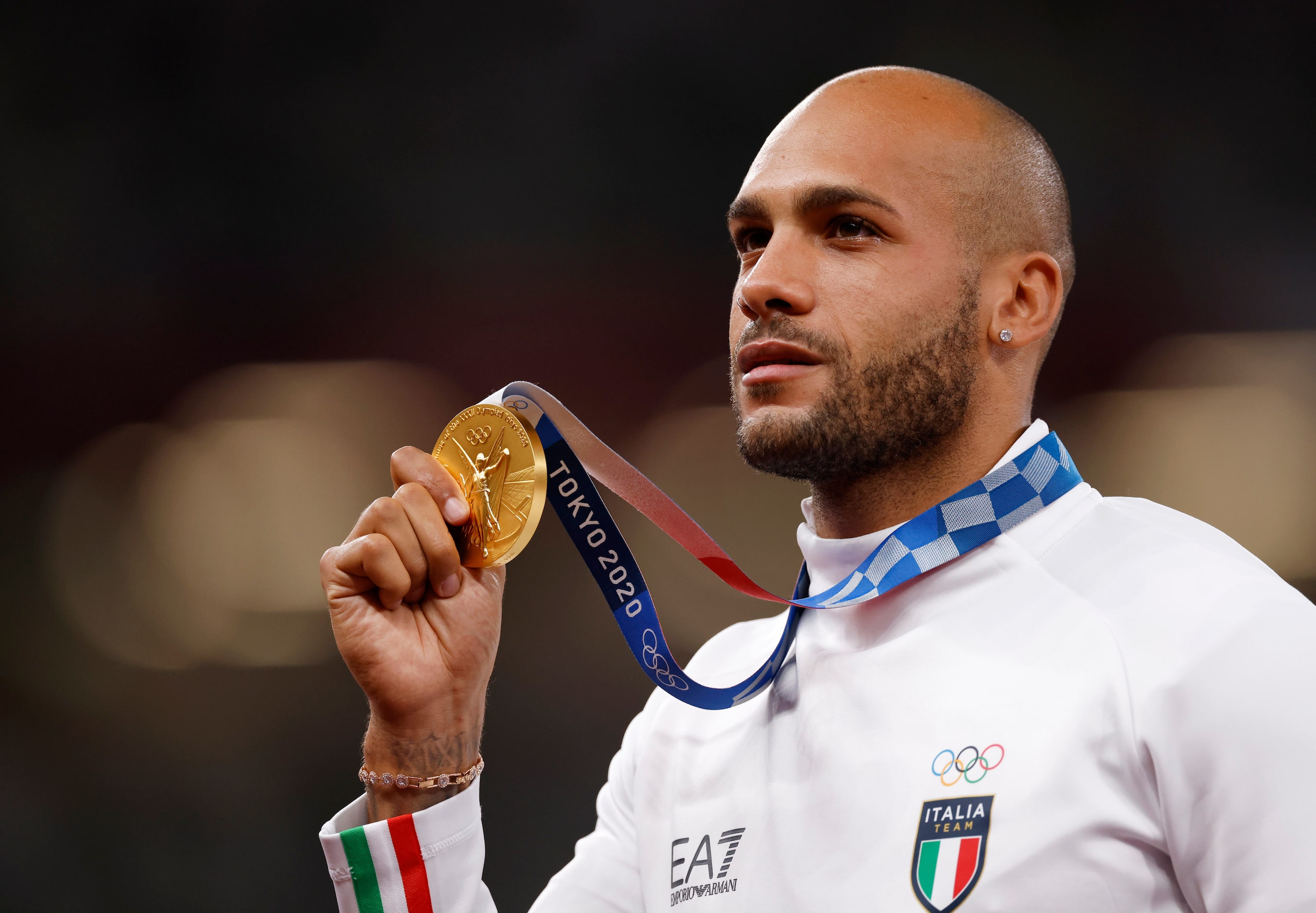 Italy’s Lamont Marcell Jacobs poses with his gold medal earned as the winner of the men’s...