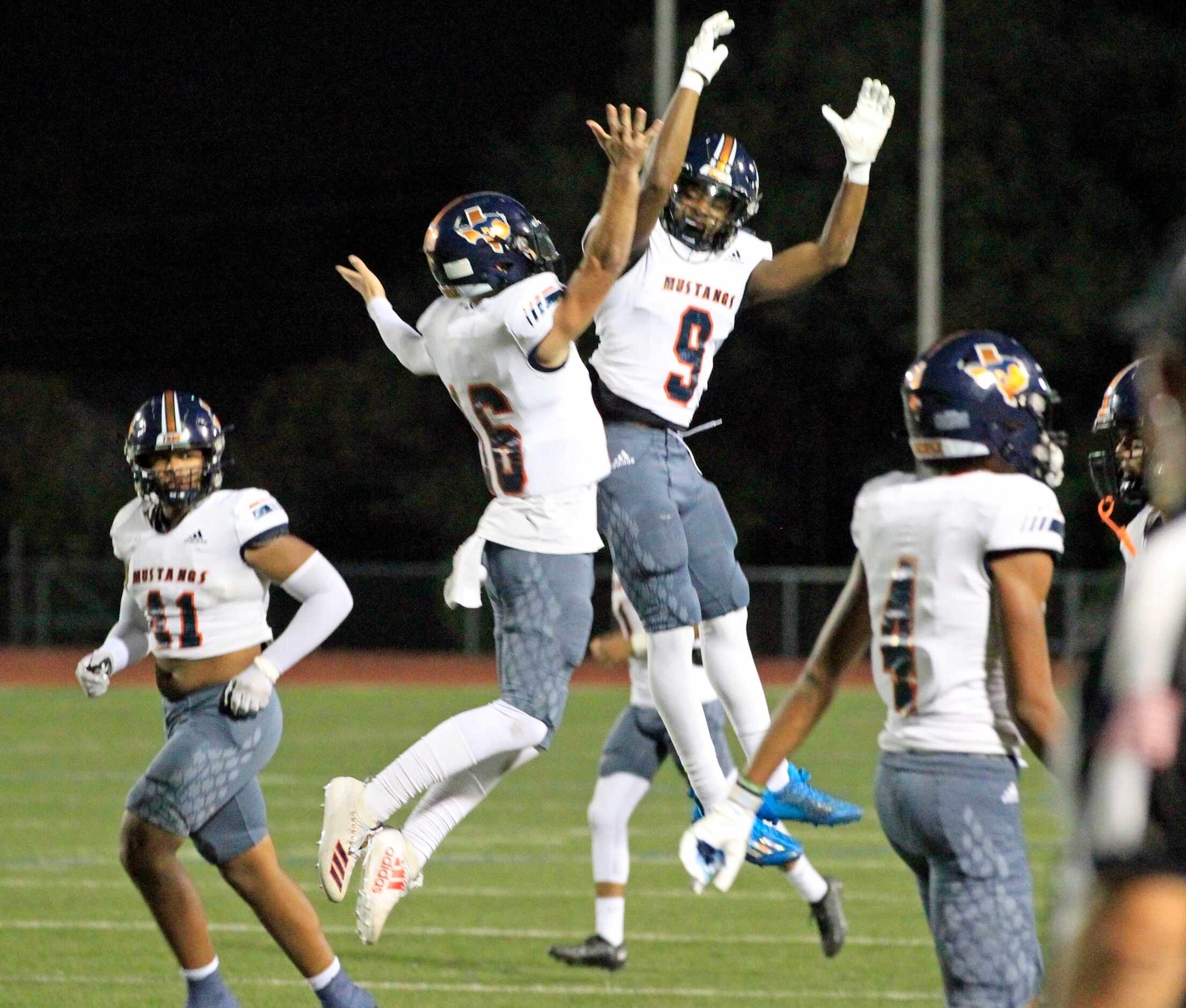 Sachse High players  Brenden George (16) and Kendrick Hanks (9) jump for joy after George’s...