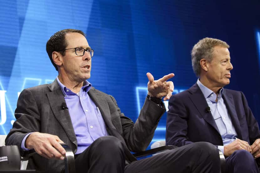 Randall Stephenson, chairman and chief executive officer of AT&T Inc., left, speaks while...