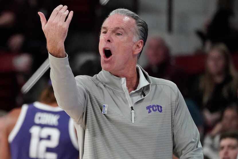 TCU head coach Jamie Dixon gestures toward his players during the second half of an NCAA...