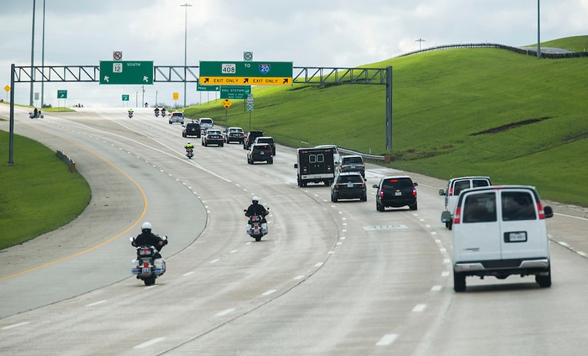  The presidential motorcade drives south on Walton Walker Blvd toward Dallas National Golf...