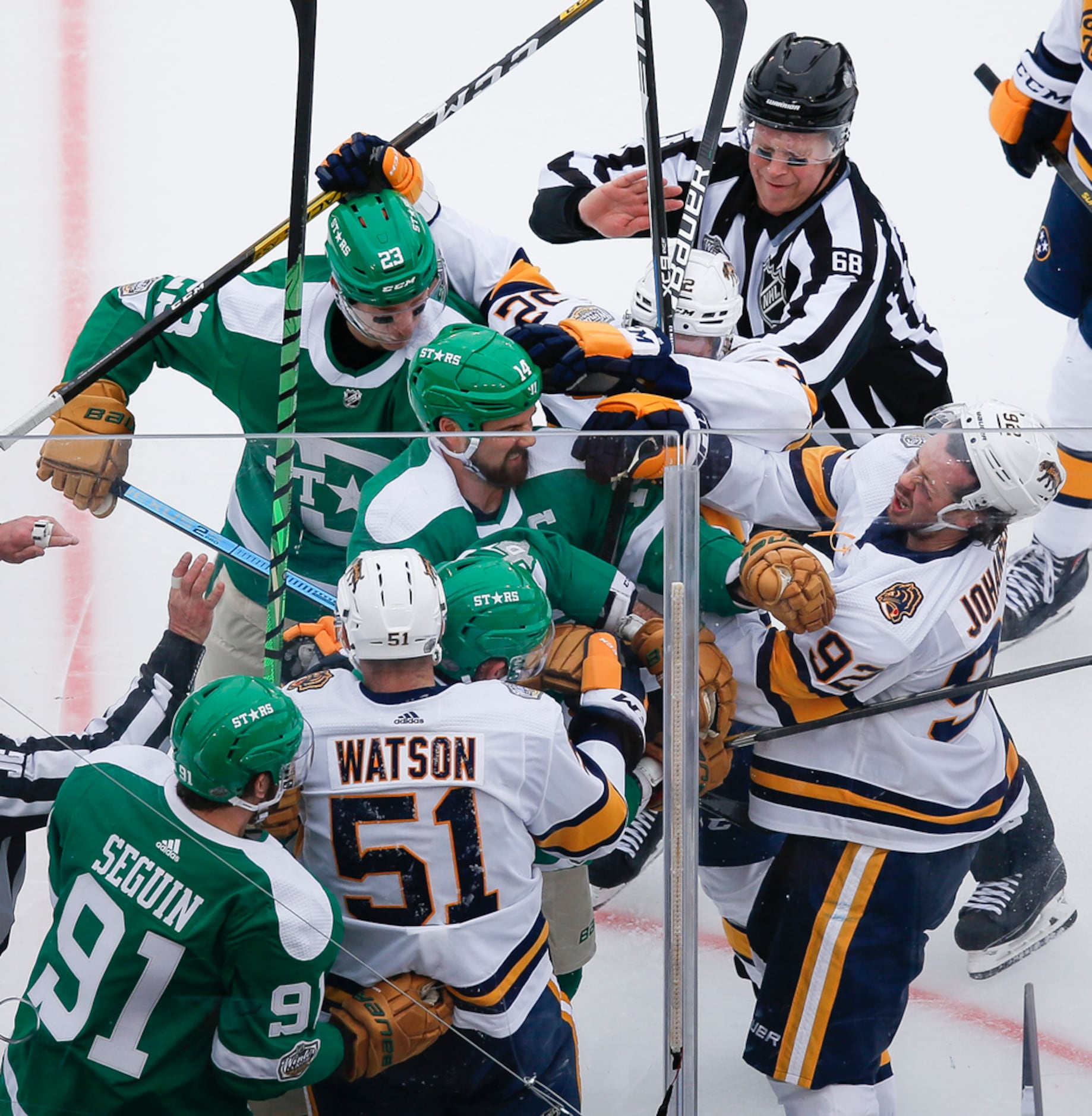 Players fight during the second period of a NHL Winter Classic matchup between the Dallas...