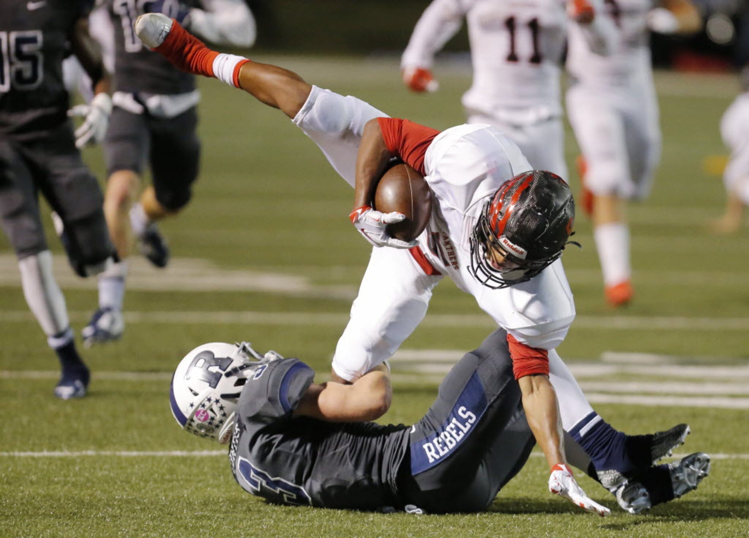 Richland's Colton Curtis (3) tackles Colleyville Heritage senior punt returner Reid...