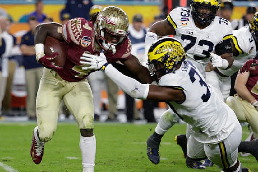 FILE - In this Dec. 30, 2016, file photo, Florida State running back Dalvin Cook (4) runs...