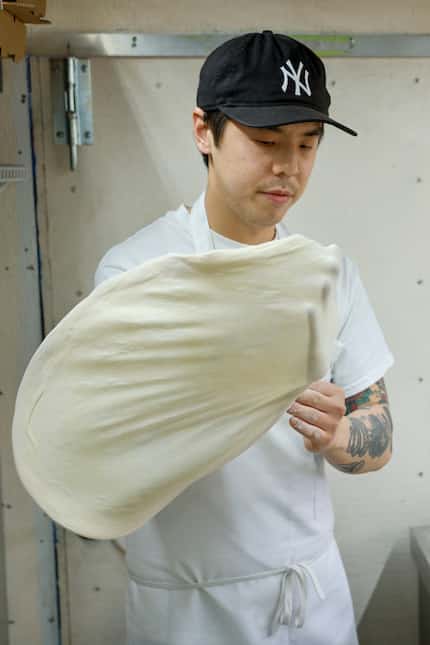 Peter Cho stretches dough to make a Nice Pizza.