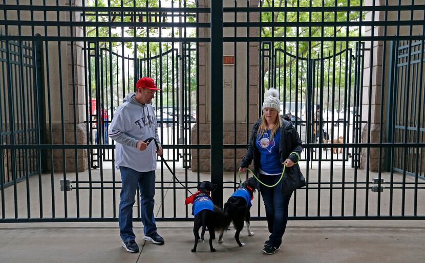 Steve Rose, left, and his wife Janee Rose, right, make their way to the Rangers vs. Blue...