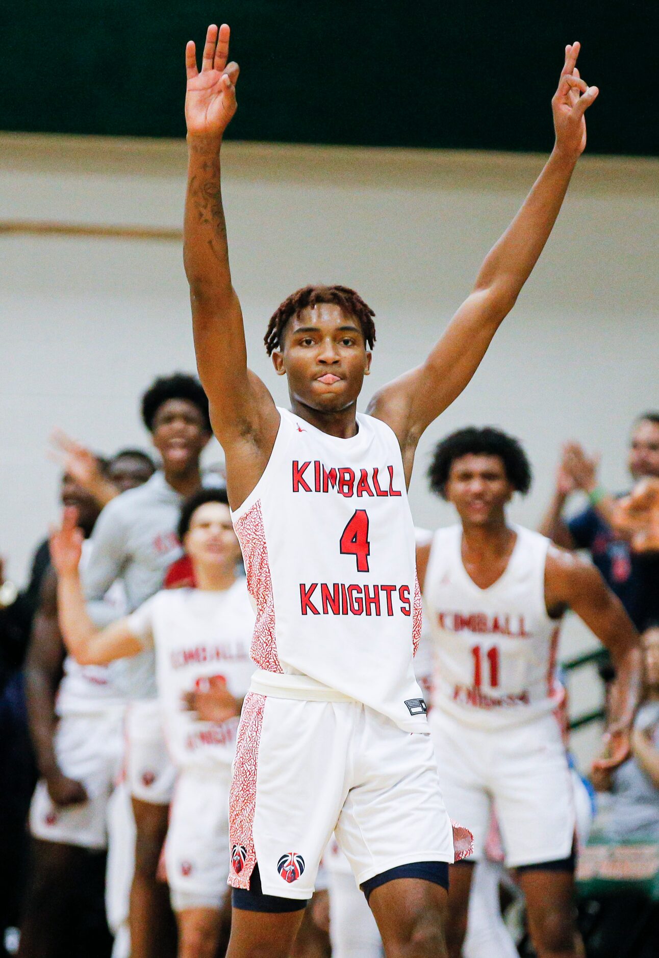 Kimball sophomore Arterio Morris celebrates a three-pointer during the first half of a Class...