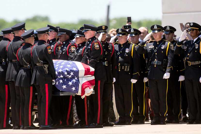 Honor guard members carried the casket of Grand Prairie officer A.J. Castaneda during...