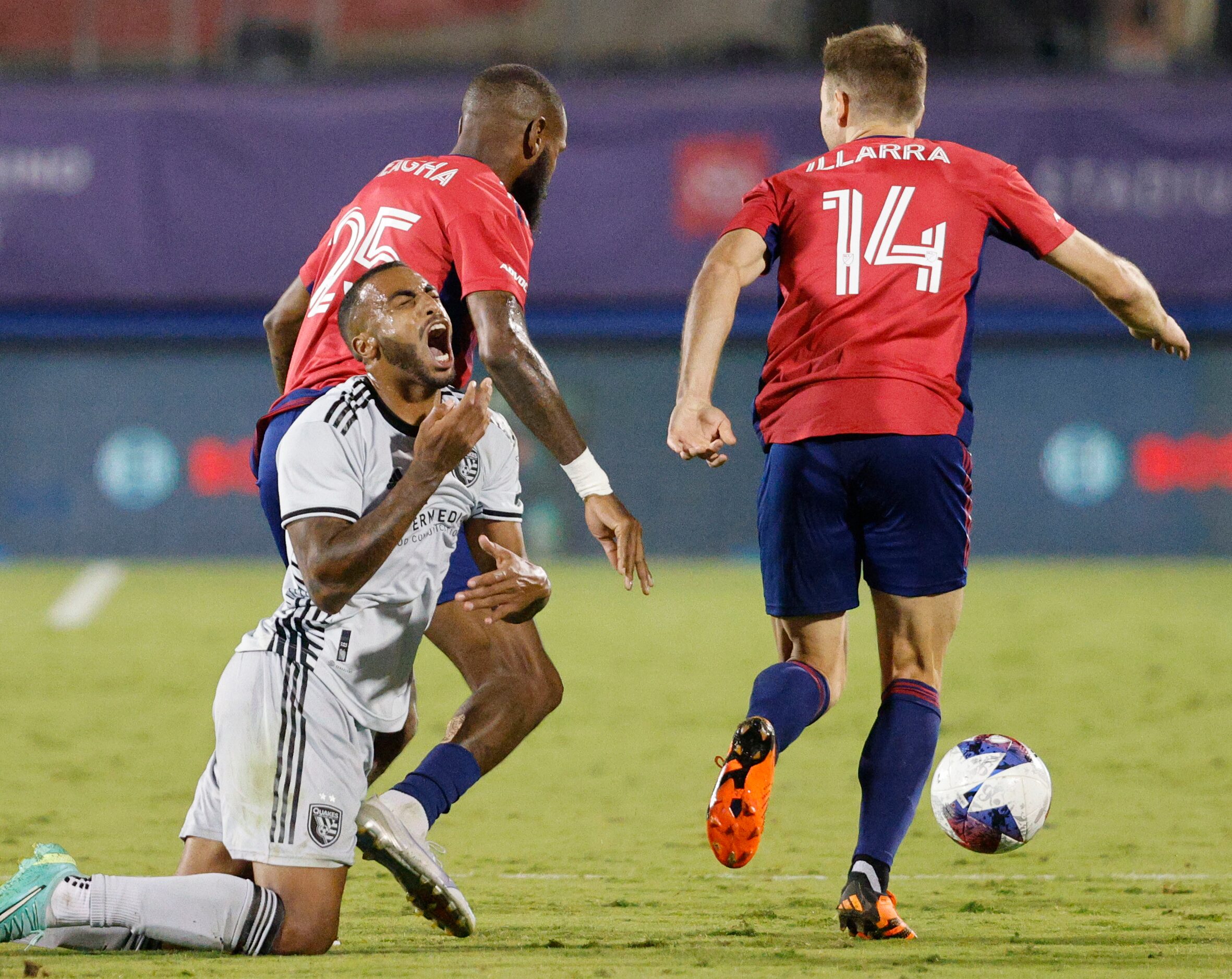 San Jose Earthquakes defender Carlos Akapo (29) tangles with FC Dallas defender Sebastien...