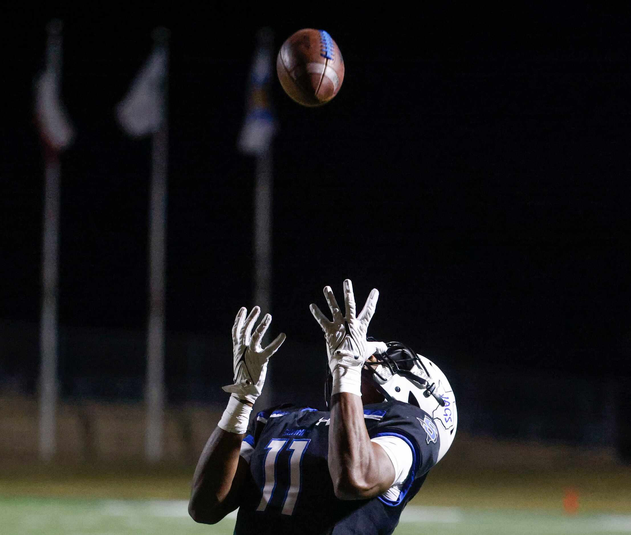 Mansfield Summit High’s Dorian Mcdade reaches to receive a touchdown pass against Ennis High...
