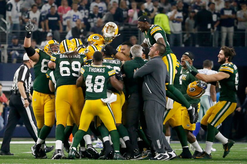 Green Bay Packers players celebrate a 34-31 win over the Dallas Cowboys at AT&T Stadium in...