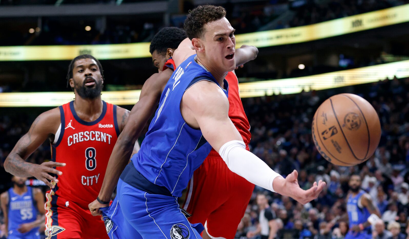 Dallas Mavericks center Dwight Powell (7) tries to gather an offensive rebound against the...