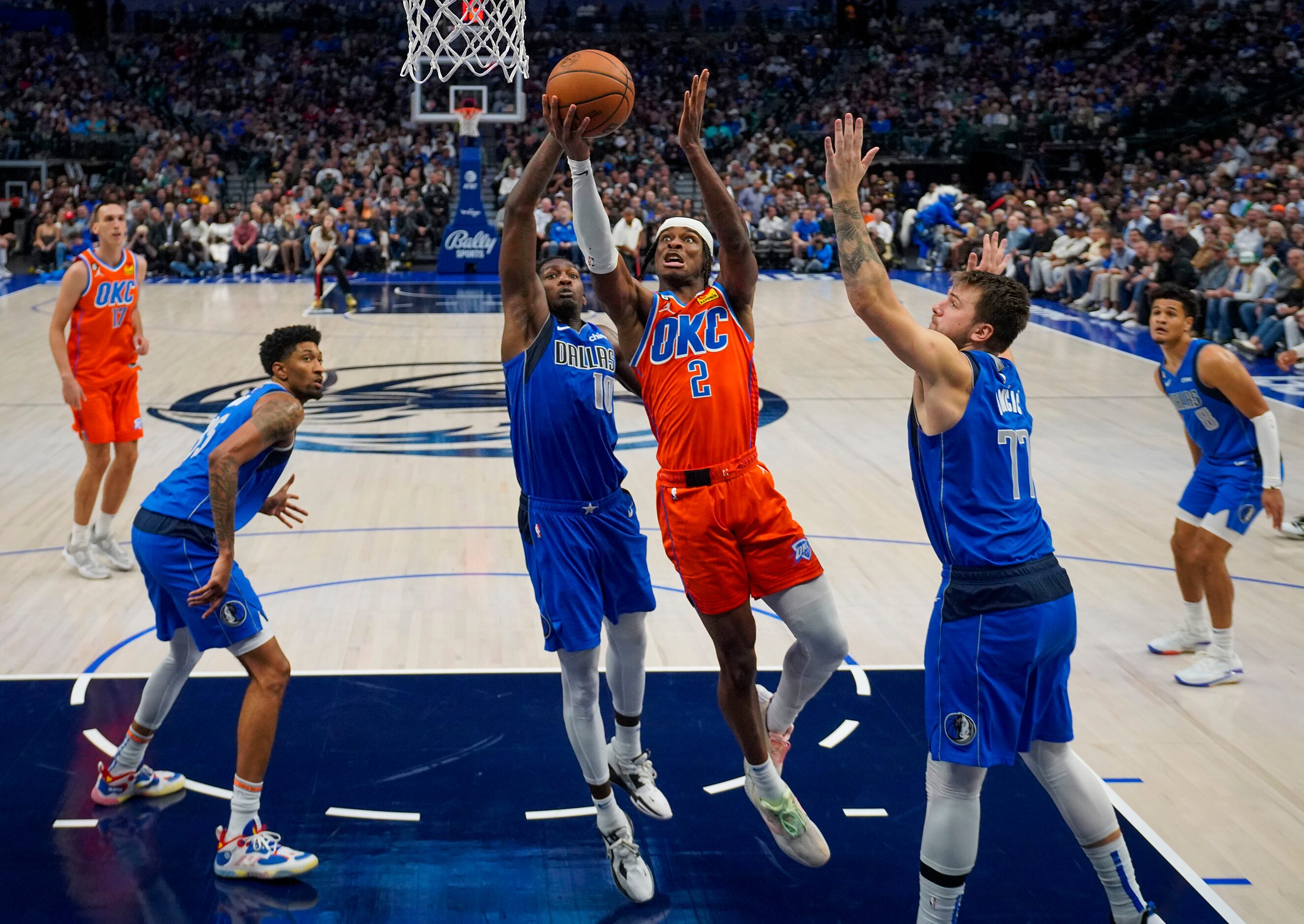 Oklahoma City Thunder guard Shai Gilgeous-Alexander (2) scores past Dallas Mavericks guard...