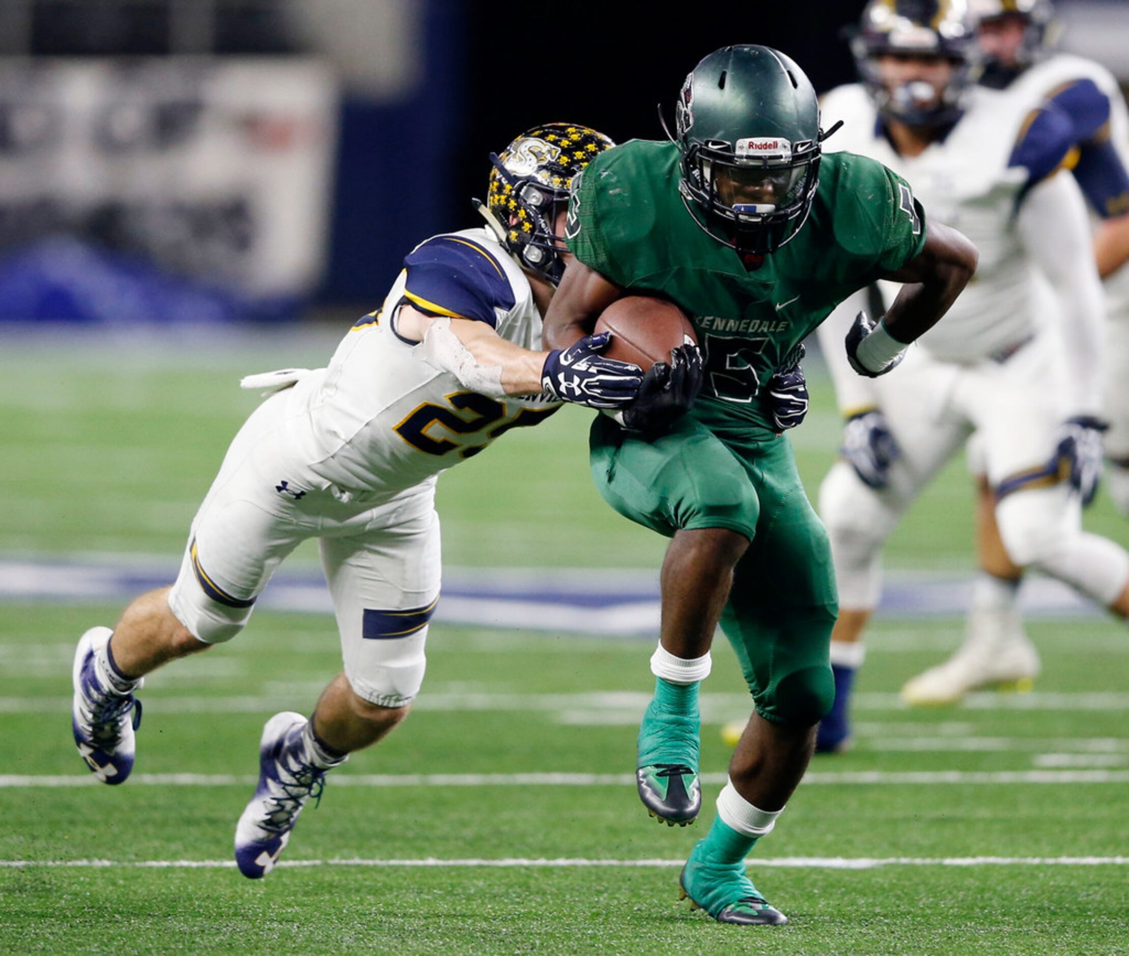 Kennedale's Jaden Knowles (5) breaks away from Stephenville's Gage Graham (25) on his way to...