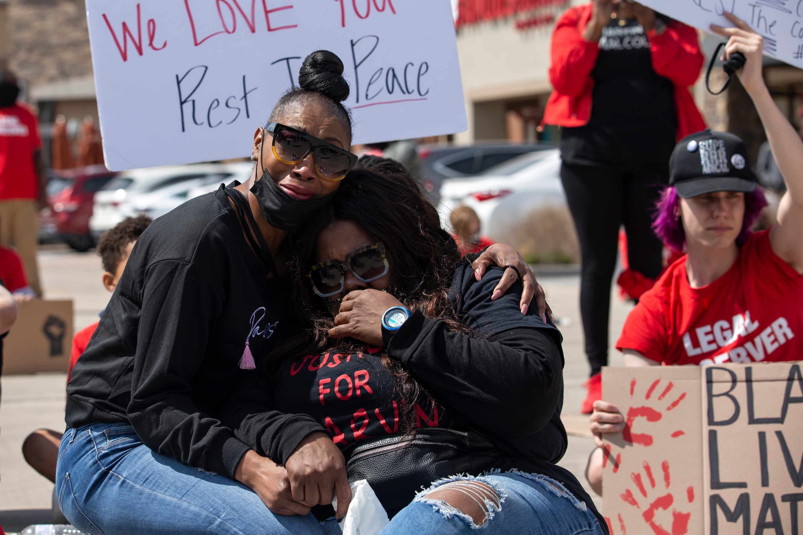 Pynun Stevenson comforts Lassandra Scott at the Allen Outlets on Sunday, March 21, 2021...