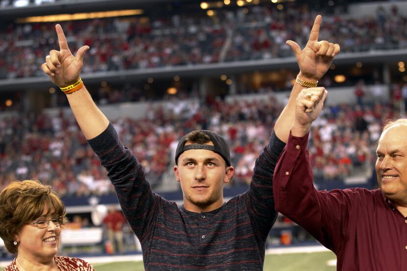 Former Texas A&M Aggies quarterback Johnny Manziel acknowledges the crowd after receiving...