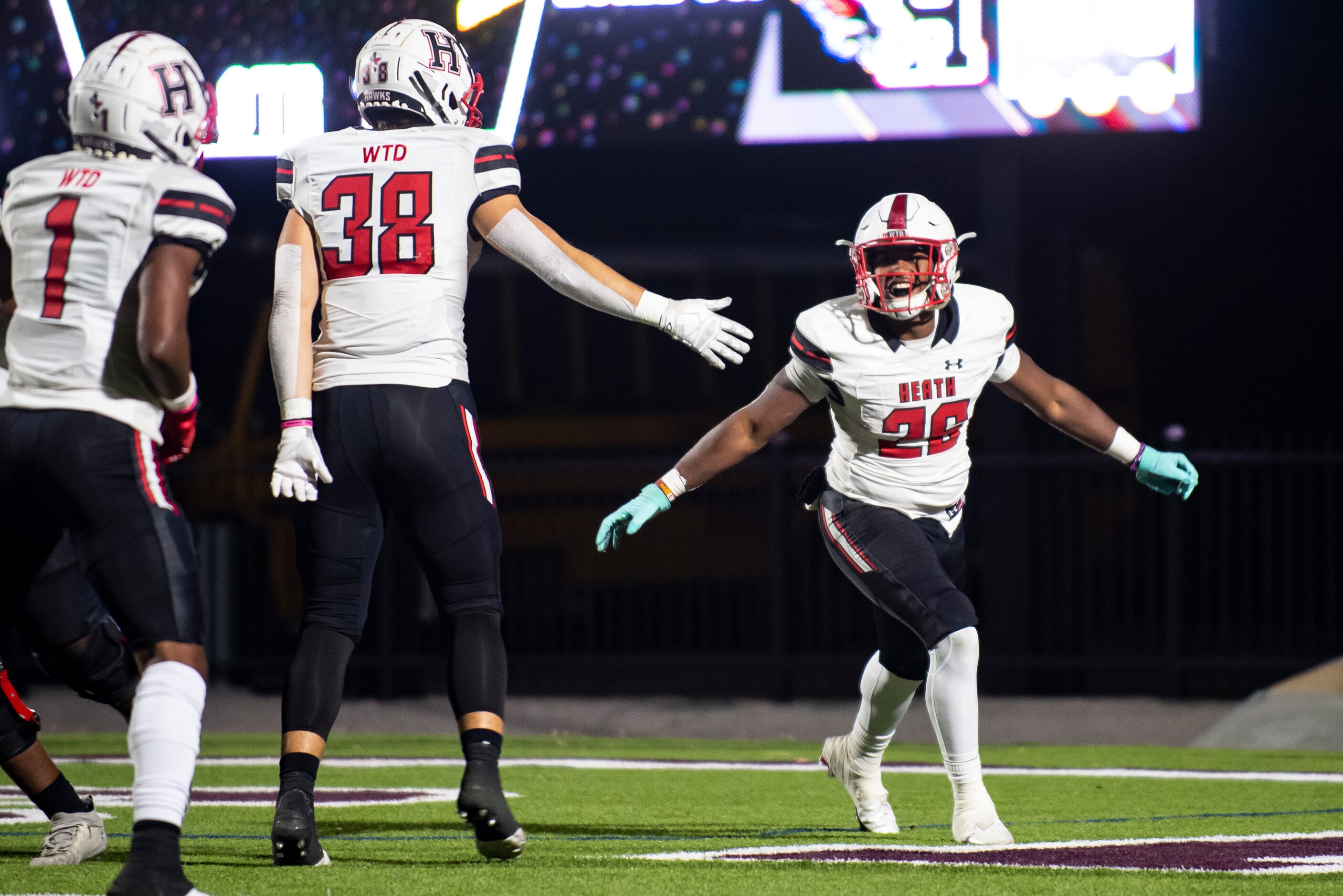 Heath senior Zach Evans (26) celebrates after scoring another touchdown in the first half...