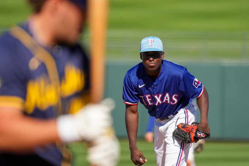 Texas Rangers pitcher Emiliano Teodo looks in as Milwaukee Brewers designated hitter Brock...