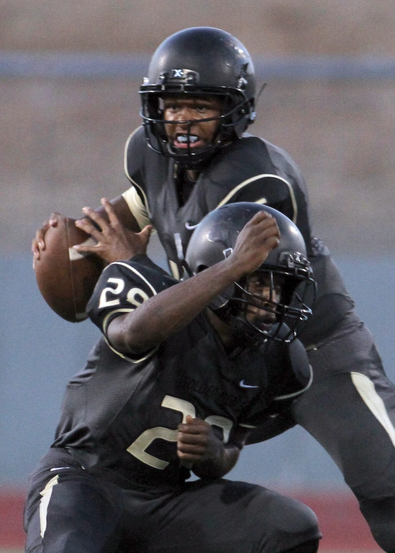 South Oak Cliff quarterback David Johnson (15) rolls out of the pocket in search of an open...