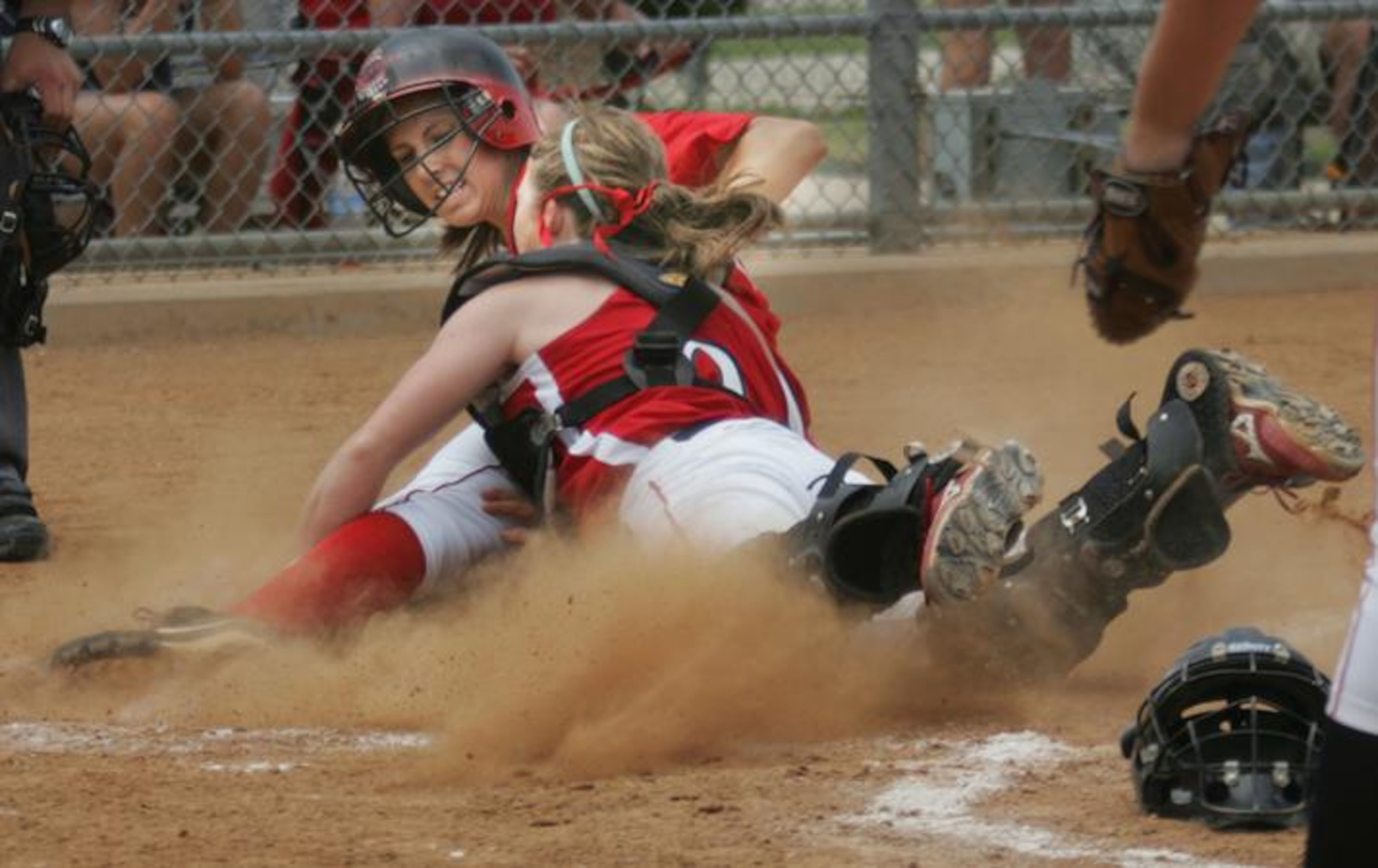 Coppell sophomore Amber Clifford (left) is tagged out at home by Justin Northwest sophomore...