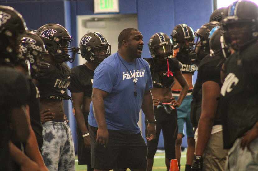 North Crowley head coach Ray Gates works with his players at a practice on Monday, Sept. 12.