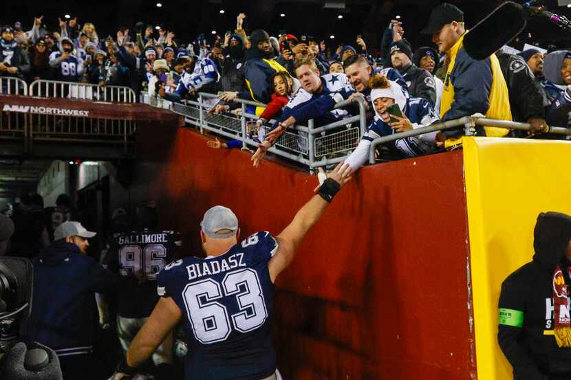 Dallas Cowboys center Tyler Biadasz (63) high-fives fans after an NFL football game on...