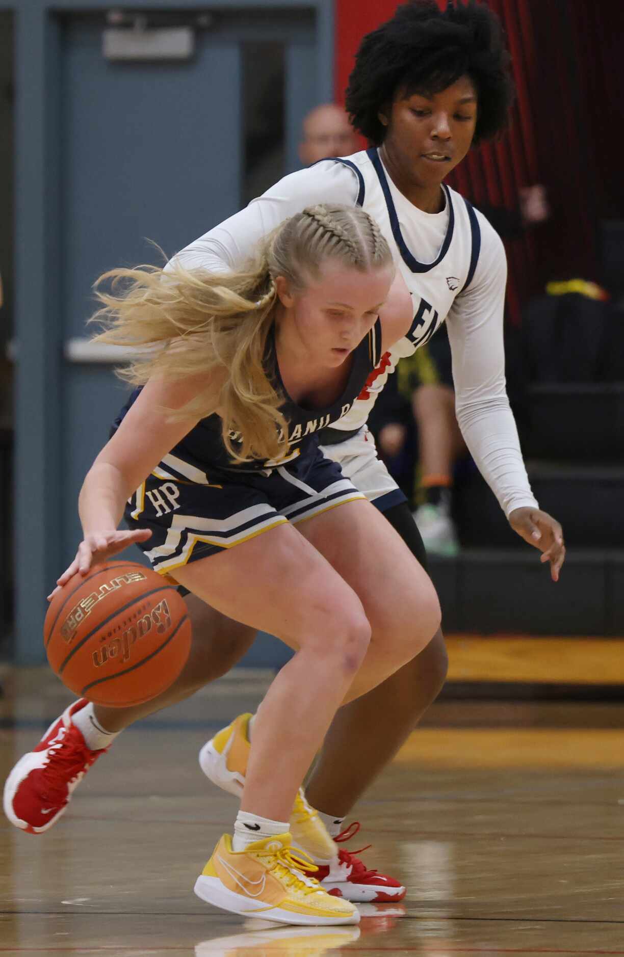 Highland Park guard Tyler Corwin (2) works to maintain ball control as she is defended by...
