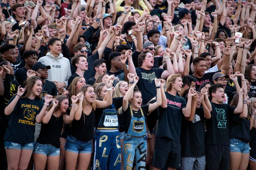 The Plano East students section cheers before the opening kickoff of a high school football...
