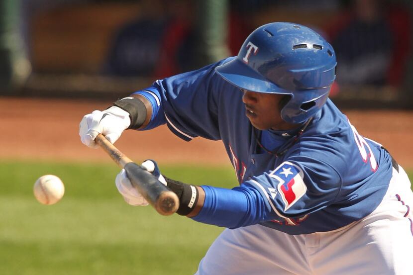 Texas Rangers player Jurickson Profar lays down a bunt as they played the Cleveland Indians...