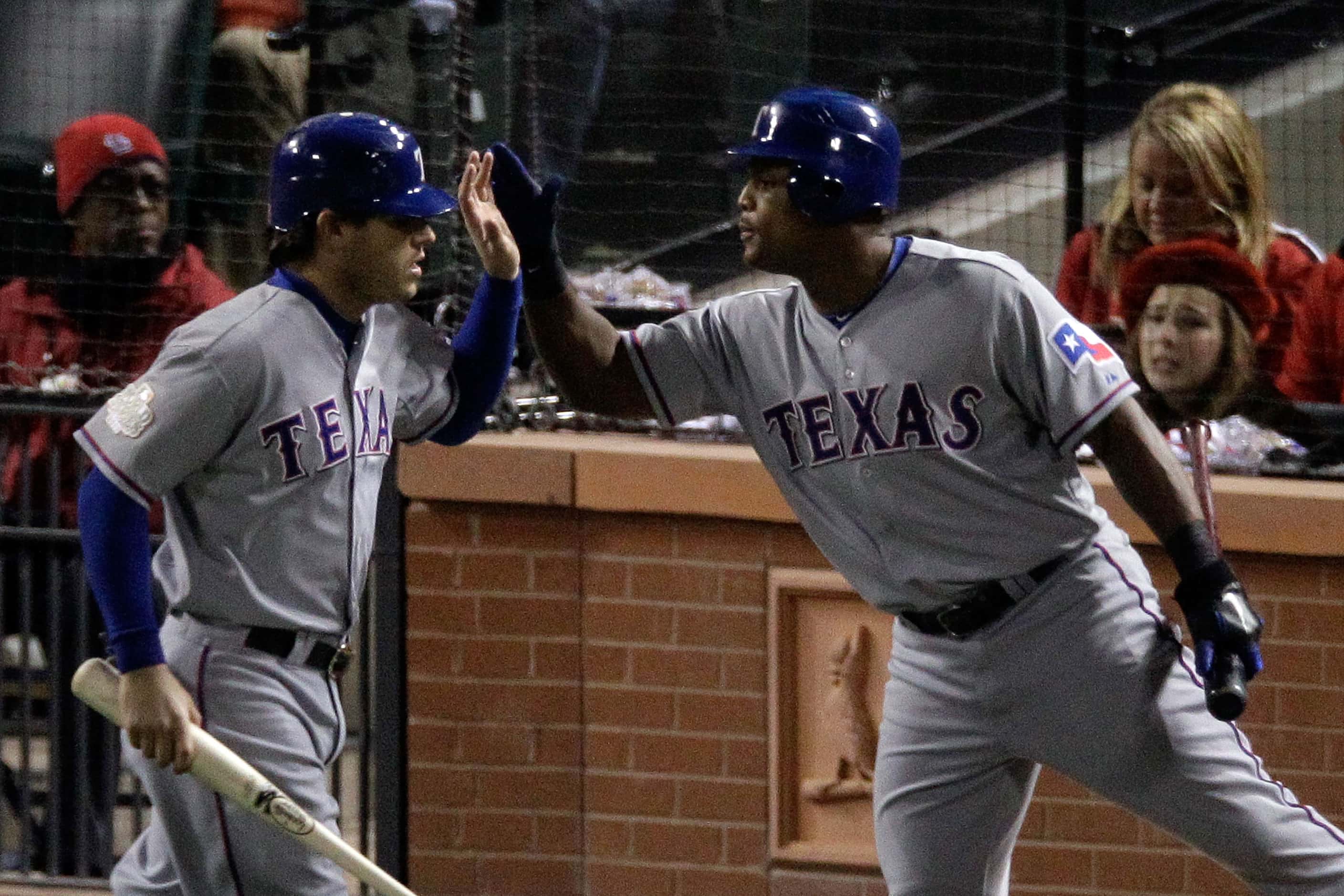 Ian Kinsler (left) and Adrian Beltre high five in the Rangers' 2011 away greys. This was one...