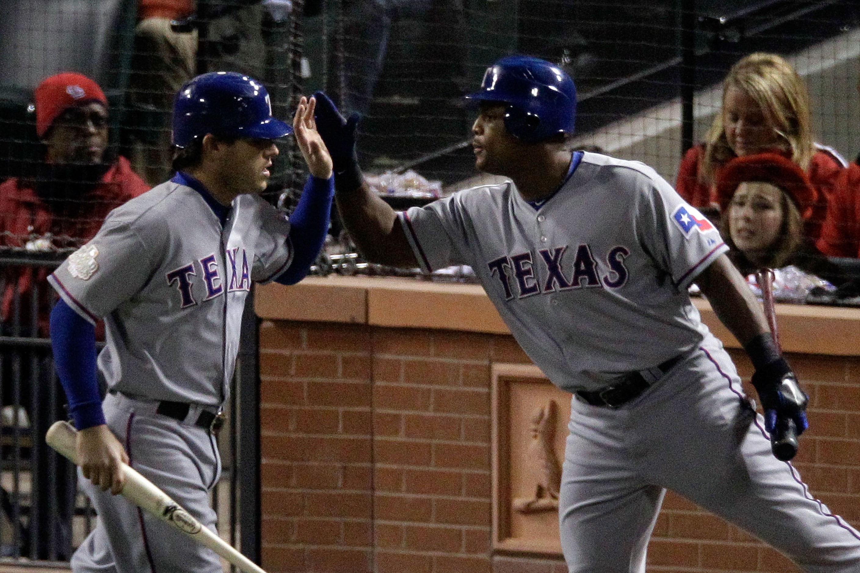 Ian Kinsler (left) and Adrian Beltre high five in the Rangers' 2011 away greys. This was one...