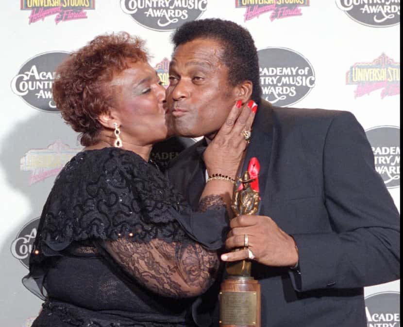 Charley Pride in 1994 getting a kiss from his wife, Rozene, after winning the Pioneer Award...