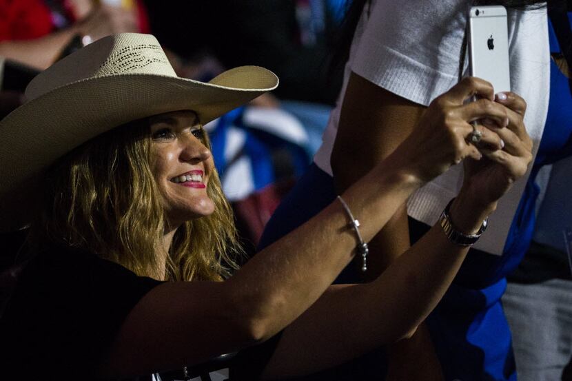 Amber Medina, a delegate from Brownsville, takes a photo with her iPhone during the...