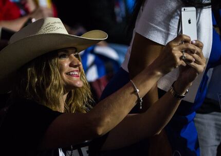 Amber Medina, a delegate from Brownsville, takes a photo with her iPhone during the...