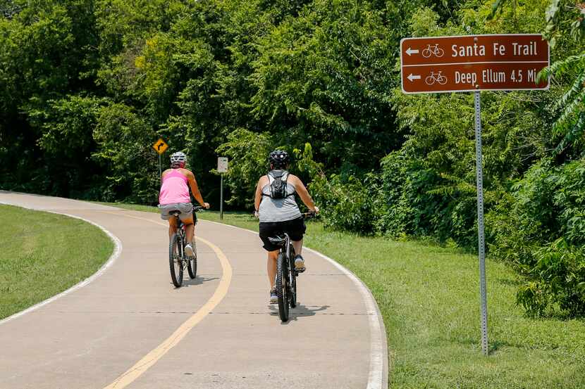 Cyclists ride along the White Rock Creek Trail at White Rock Lake in Dallas. Construction is...