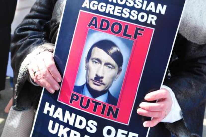 
Demonstrators with placards protest against Russian aggression in Ukraine in front of the...