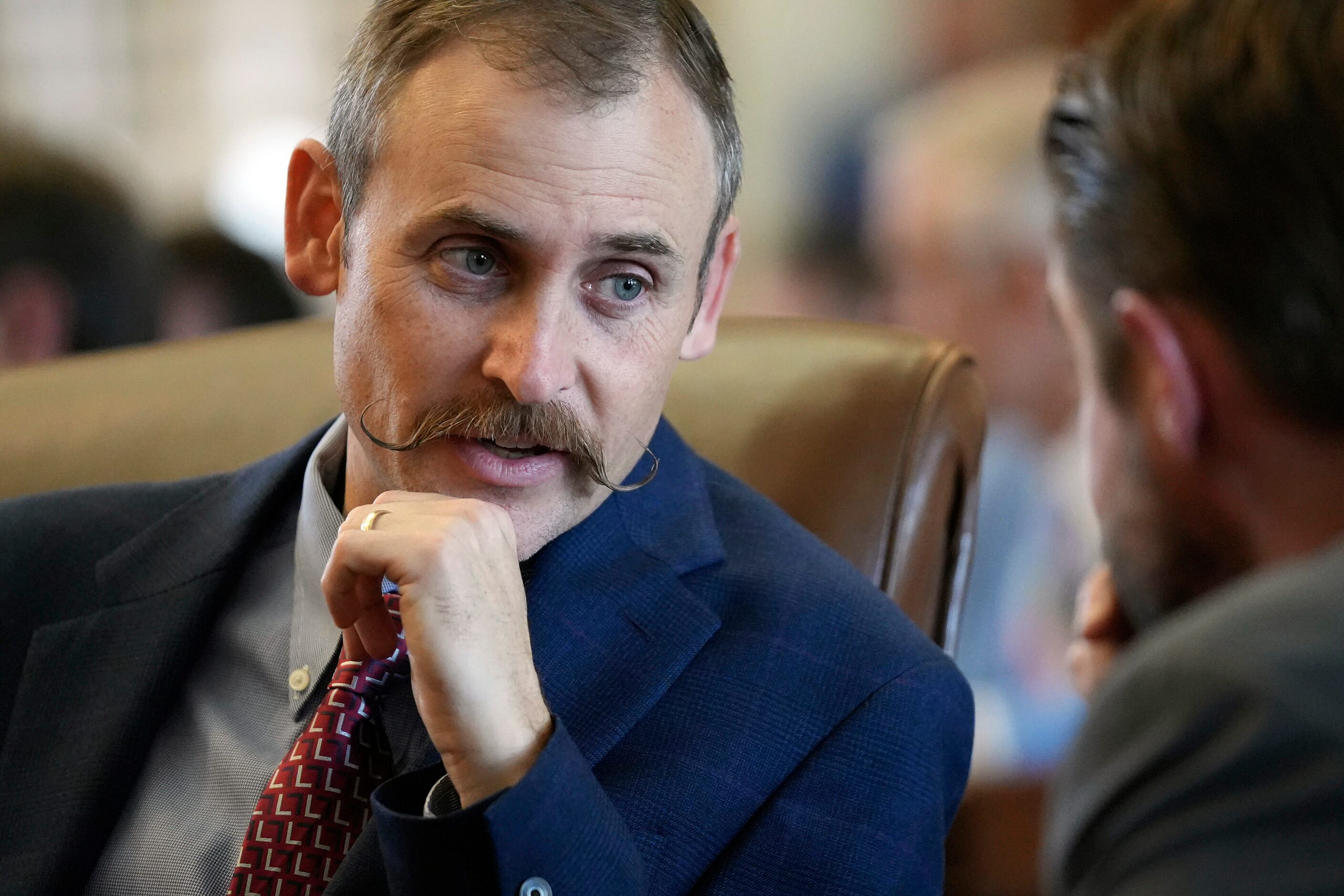 Rep. Andrew Murr, R-Junction, left, talks with Rep. Jeff Leach, R-Plano, in the House on the...