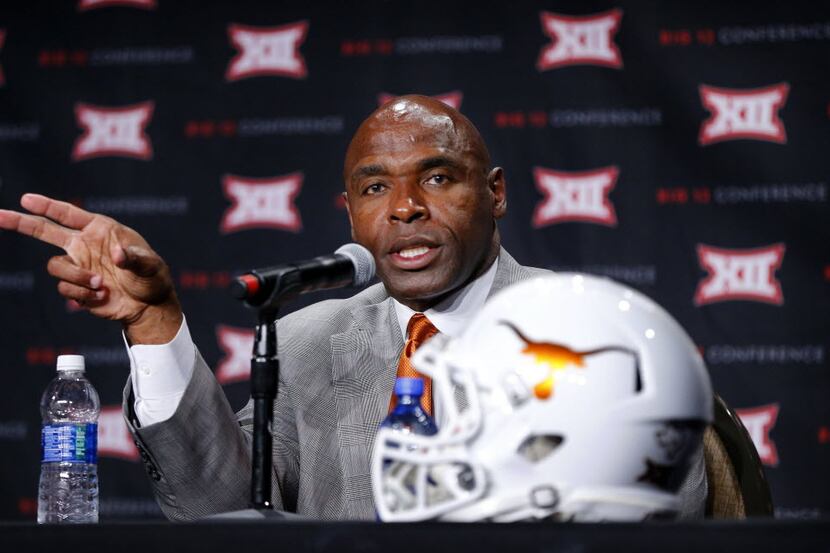 Texas head football coach Charlie Strong responds to questions from reporter assembled...