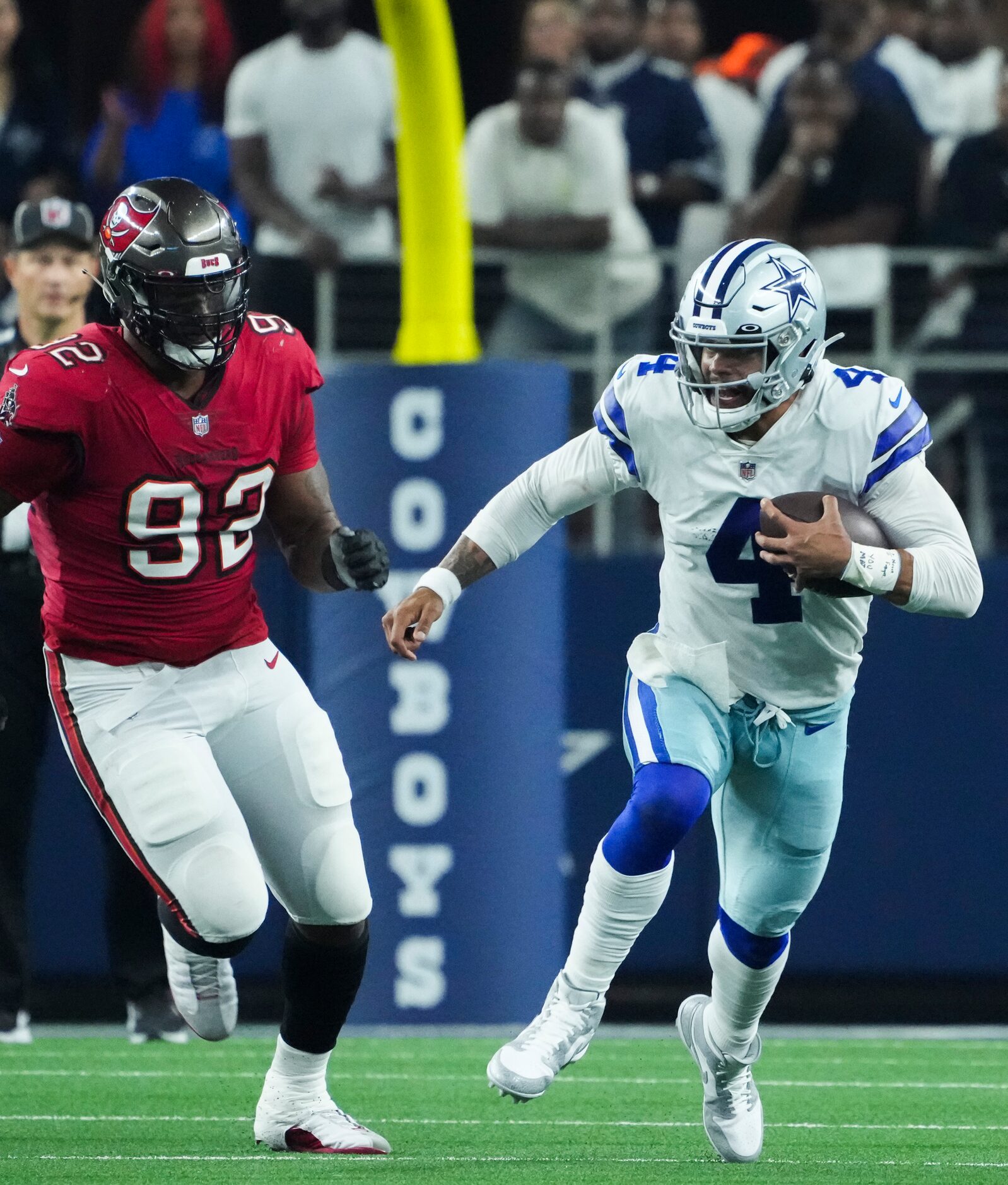 Dallas Cowboys quarterback Dak Prescott (4) scrambles for a first down past Tampa Bay...