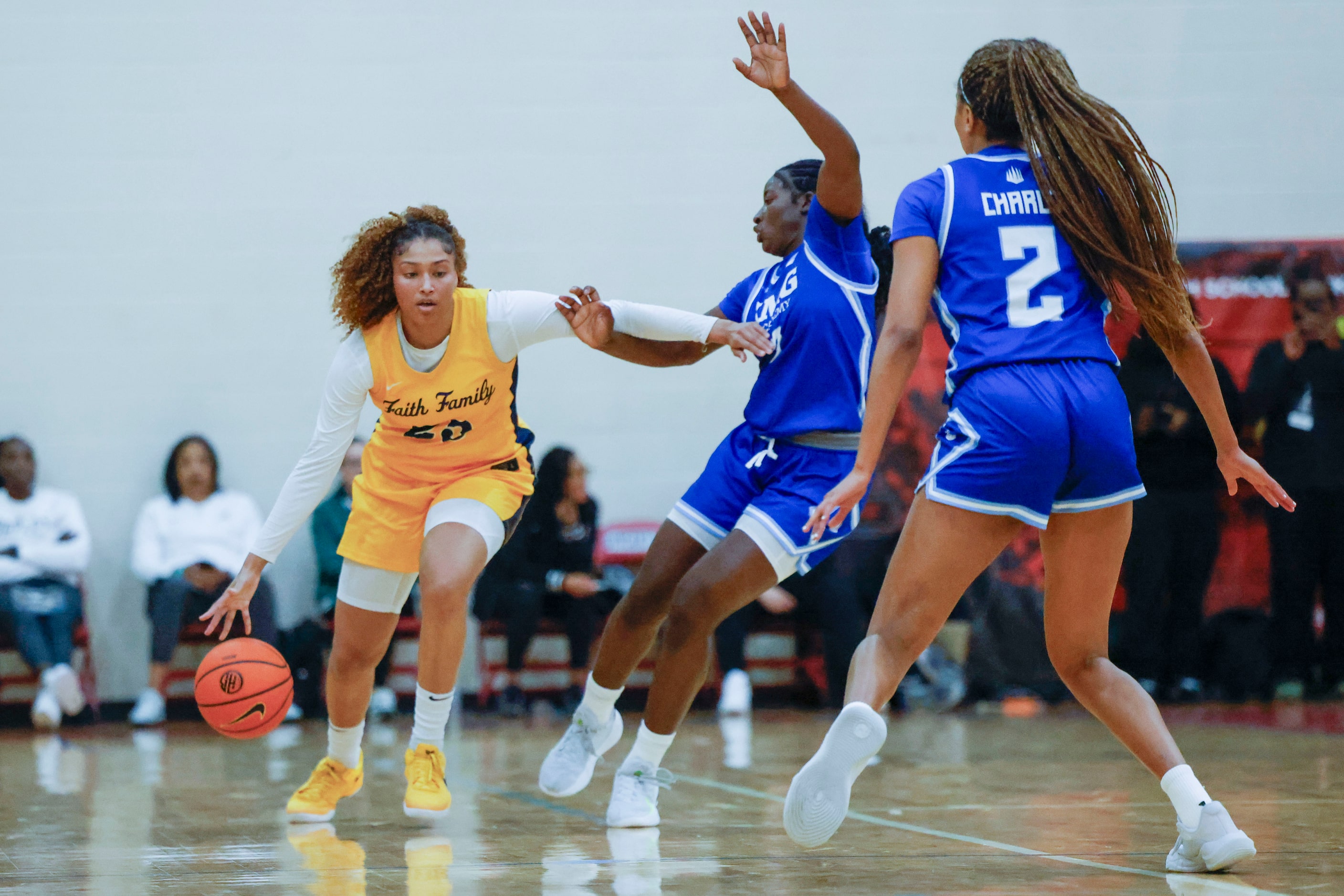 Oak Cliff Faith Family Academy’s Amayah Garcia (left)) dribbles the ball against IMG Academy...