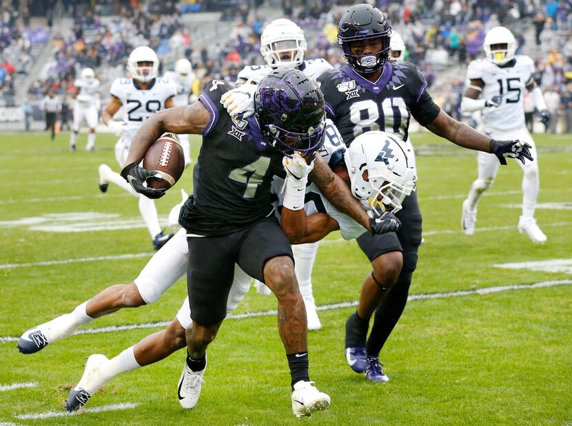 FILE - TCU wide receiver Taye Barber (4) stiff-arms West Virginia cornerback Keith...