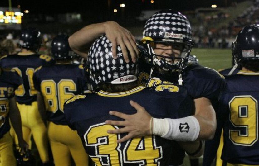 Highland Park QB Matthew Stafford celebrates with RB Alex Carroll (34) after Stafford's...