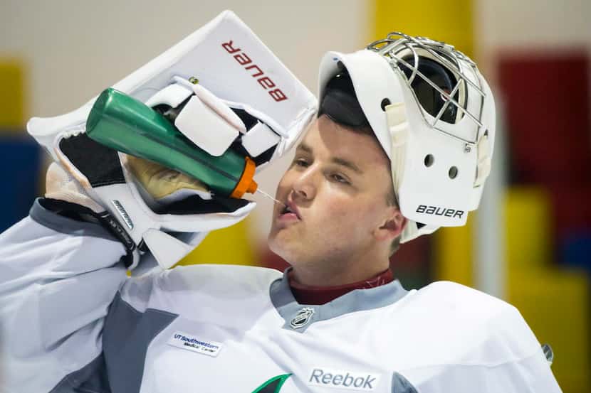 Goalie Jake Oettinger gets a drink of water between drills on the first day of Dallas Stars...