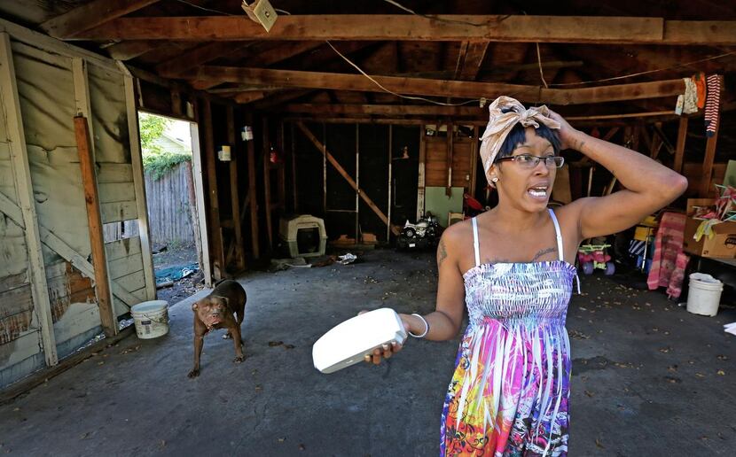 Lacye Crow talks  about the cracked beam in the garage of her home on Harding Street in...