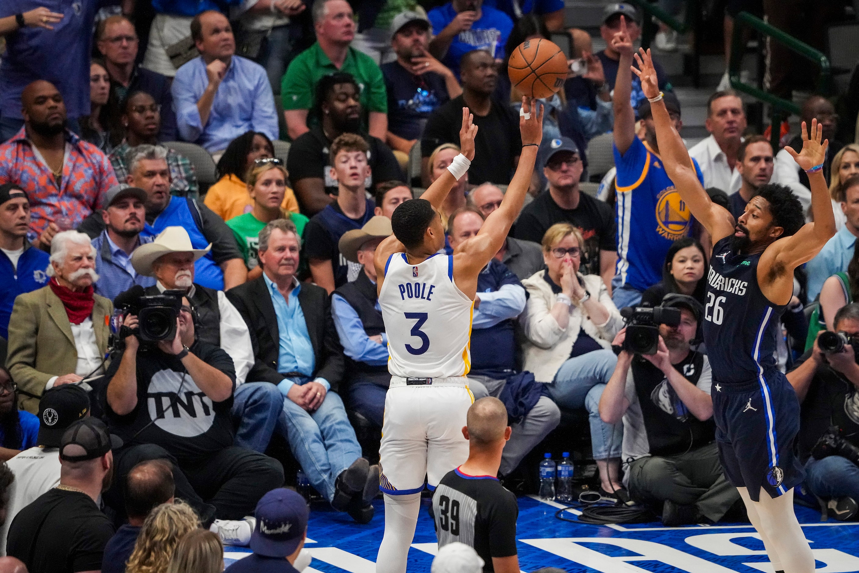 Golden State Warriors guard Jordan Poole (3) hits a 3-pointer over Dallas Mavericks guard...