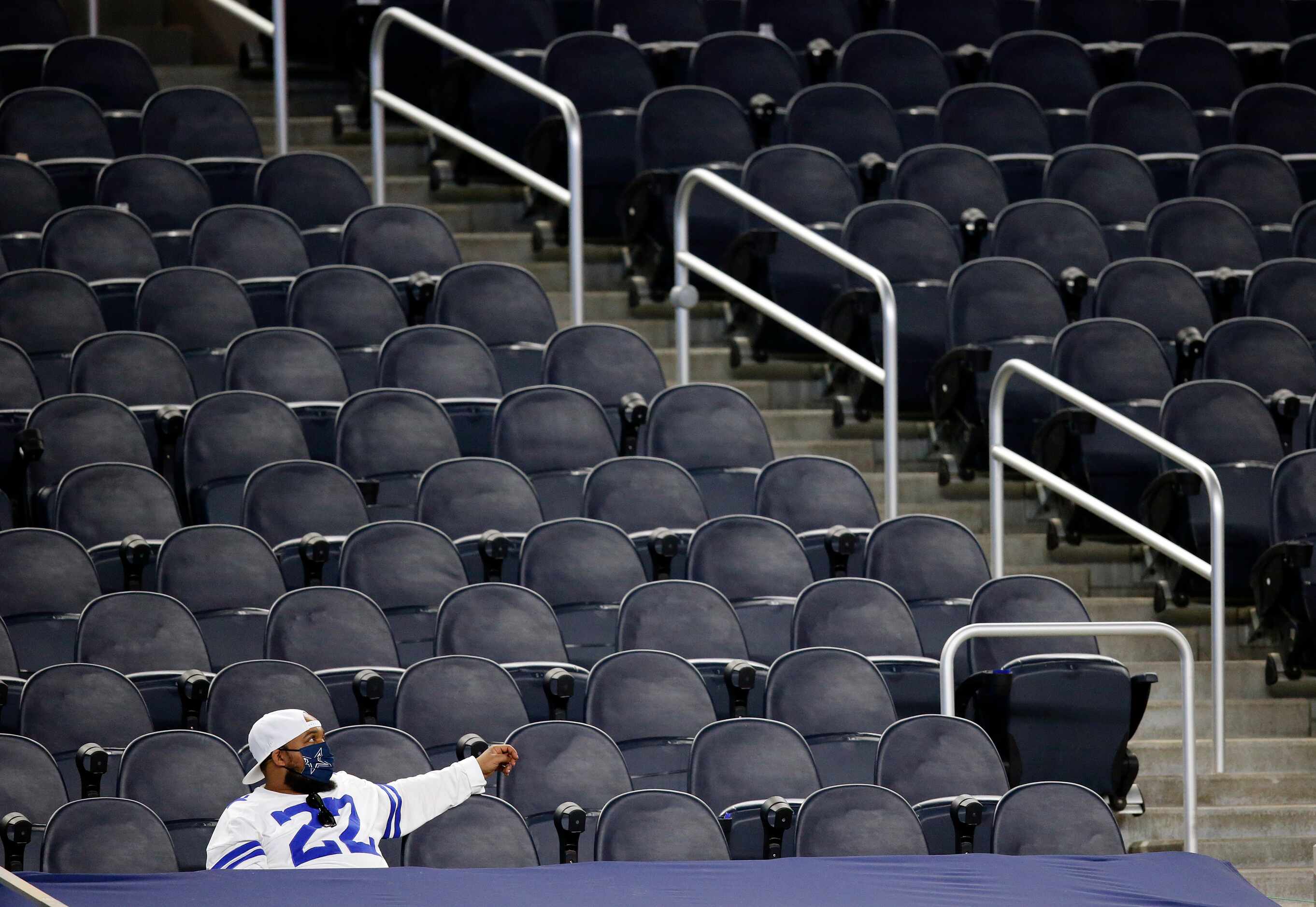 A lone Dallas Cowboys fan watches  from a nearly empty section as his team trailed the...