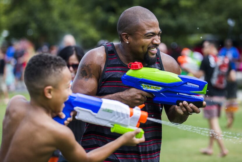 Jaylen Mayo, 8, and his dad, Ahmad Mayo, both of Denton, Texas, participate in a massive...