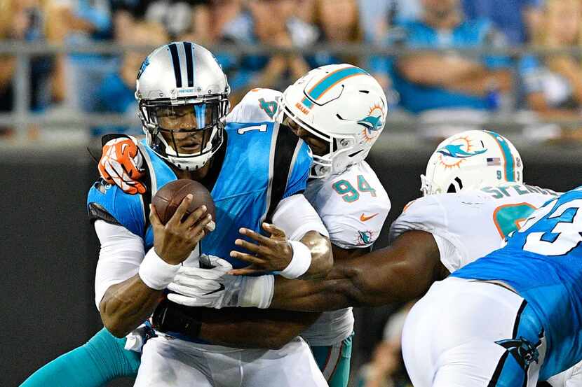 CHARLOTTE, NC - AUGUST 17:  Robert Quinn #94 of the Miami Dolphins sacks Cam Newton #1 of...