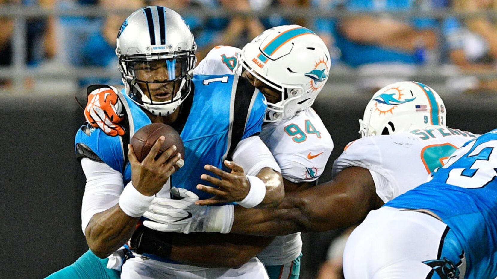 CHARLOTTE, NC - AUGUST 17:  Robert Quinn #94 of the Miami Dolphins sacks Cam Newton #1 of...